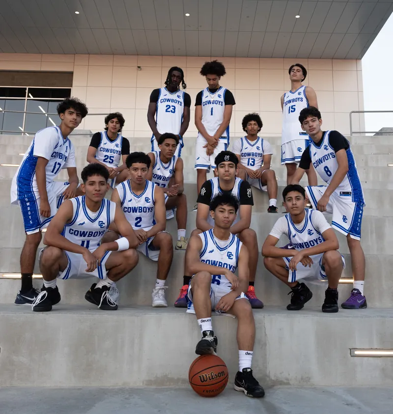 The Chino High School Cowboys in white home uniforms on the stadium steps
