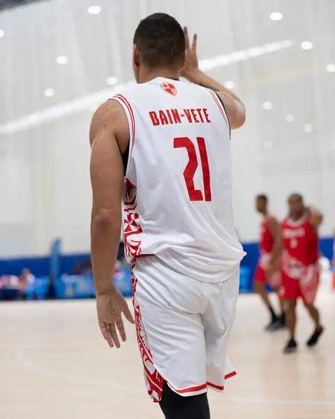 Tonga's No. 21 in the white game uniform, red patterns running down the side panels