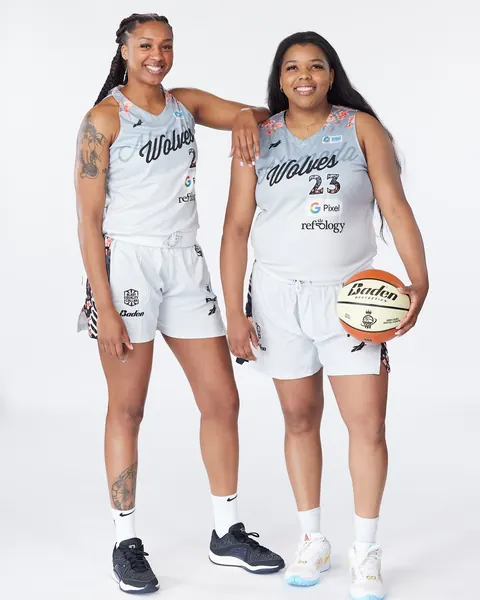 Two Alameda Wolves players in the grey cherry-blossom uniform