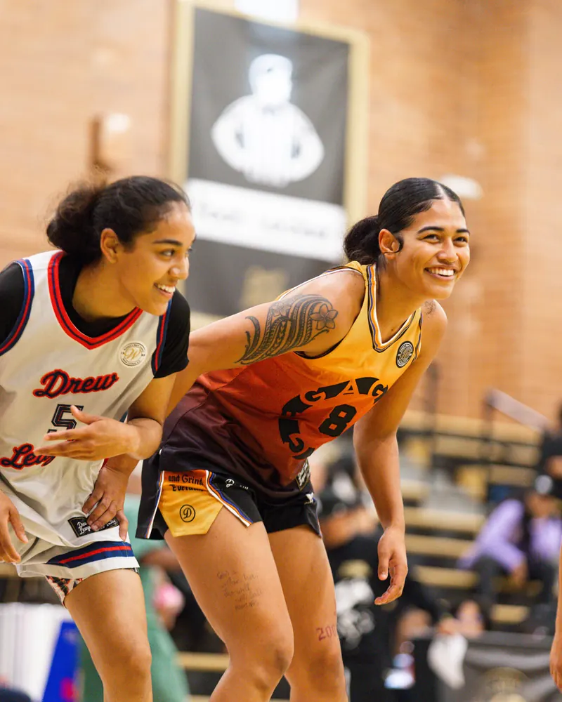 Two Drew League players smiling on court in Hemero uniforms